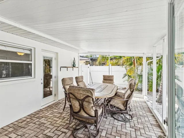 a view of a dining room with furniture and window