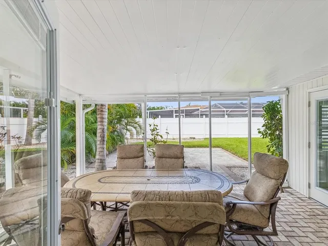 a view of a dining room with furniture large windows and wooden floor