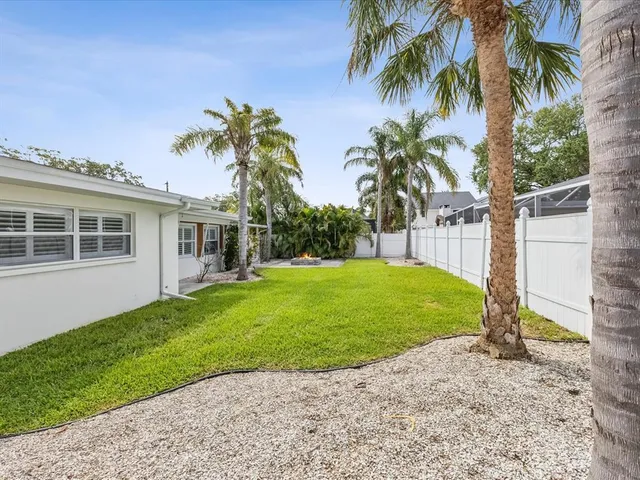 a view of a house with a backyard