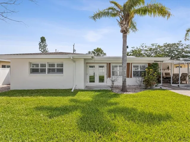 a front view of a house with a garden and yard