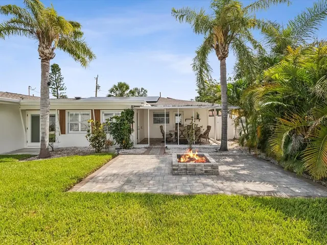 a view of a house with swimming pool and a yard