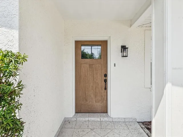 a view of a hallway with a flower pot