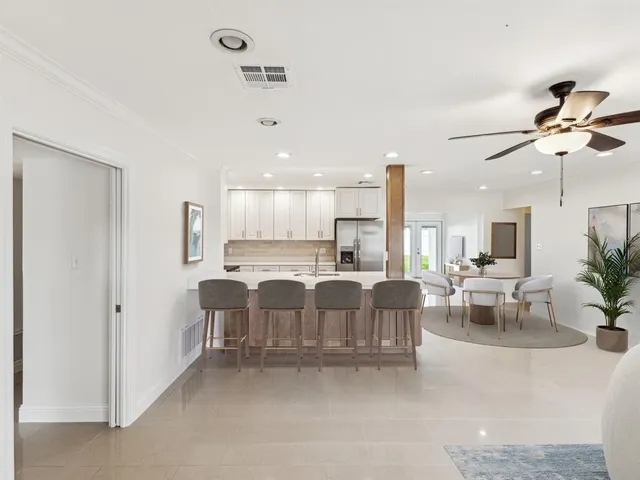 a living room with furniture a dining table and chairs