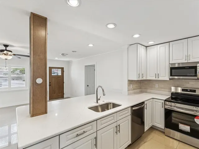 a kitchen with sink cabinets and stainless steel appliances