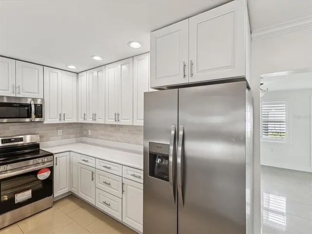 a kitchen with cabinets and stainless steel appliances