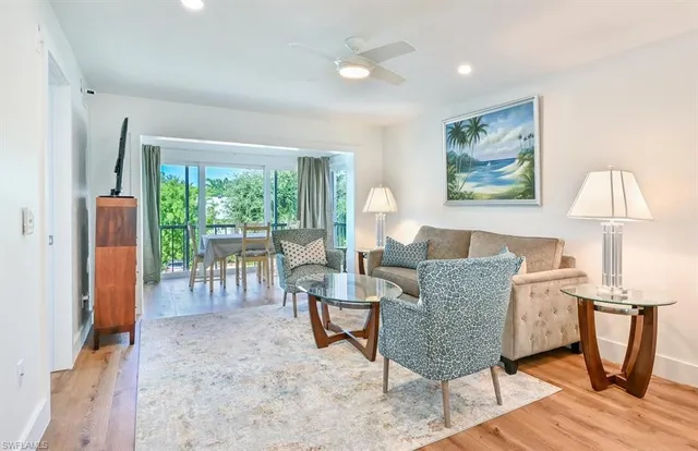 a view of a livingroom with furniture window and wooden floor
