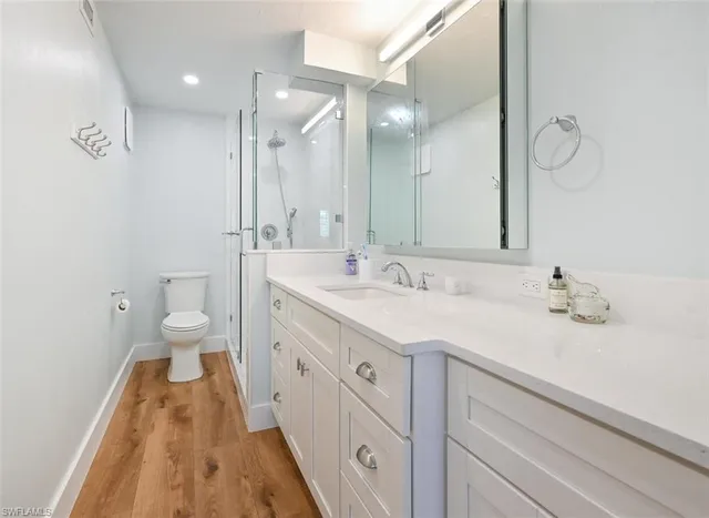 a spacious bathroom with a double vanity sink and a mirror