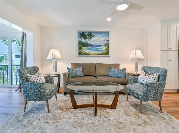 a living room with furniture and a lamp