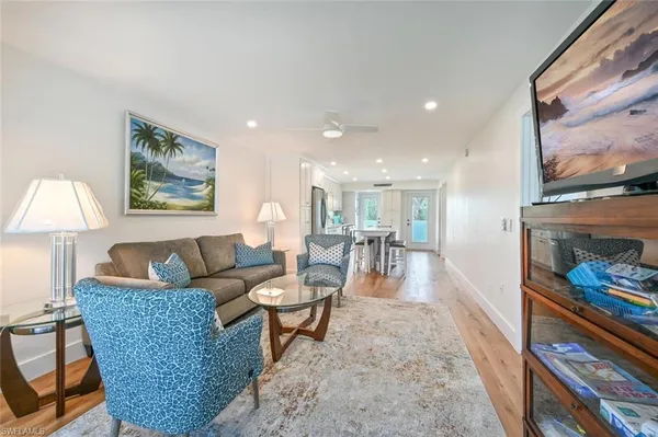a living room with furniture and a painting on the wall