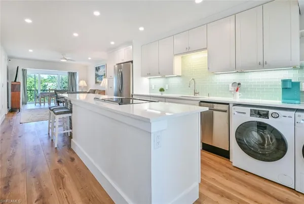 a kitchen with cabinets and wooden floor