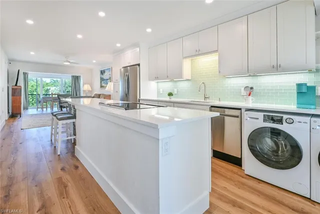a kitchen with cabinets and wooden floor