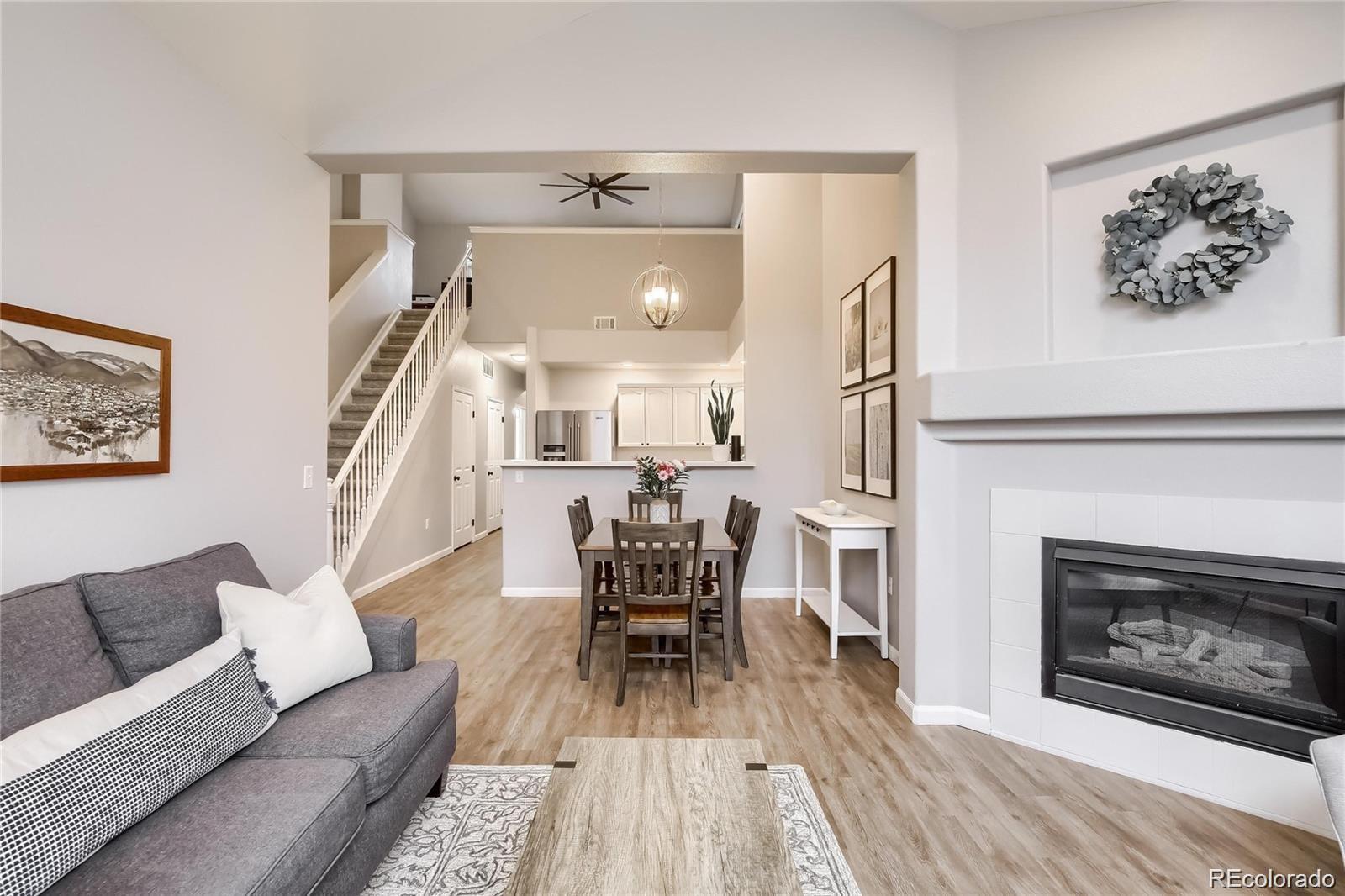 3912 South Carson Street, Unit 204 Aurora, CO 80014 - Photo 1 of 18 a living room with furniture and a fireplace