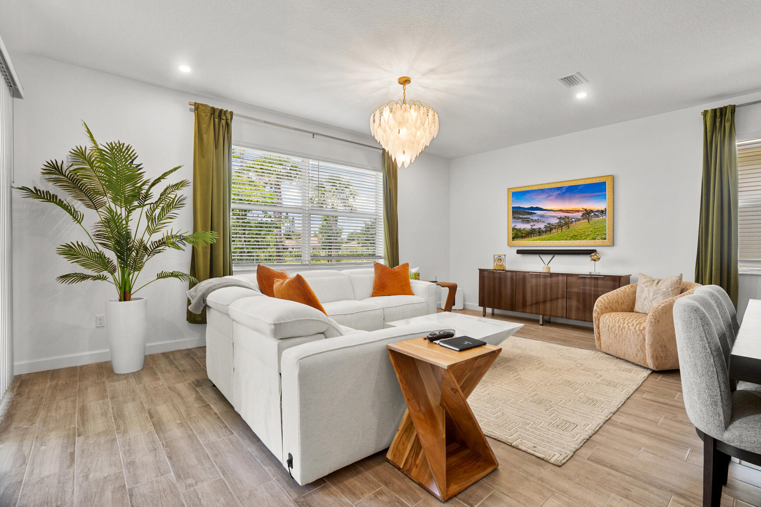a living room with fireplace furniture and a large window
