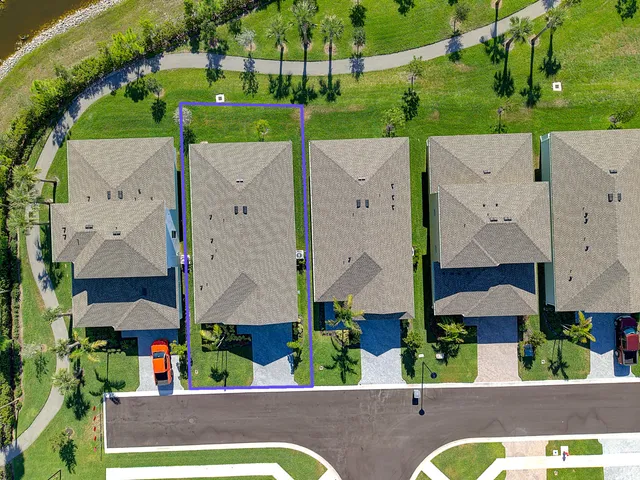 an aerial view of multiple houses with a yard