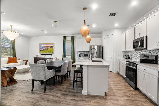 a large kitchen with a table and chairs