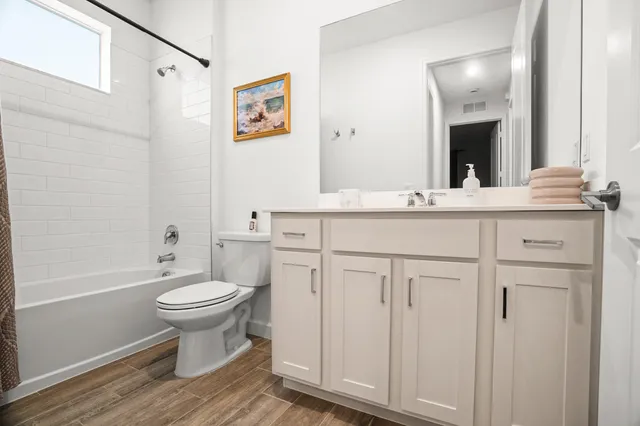 a bathroom with a sink toilet a mirror and shower