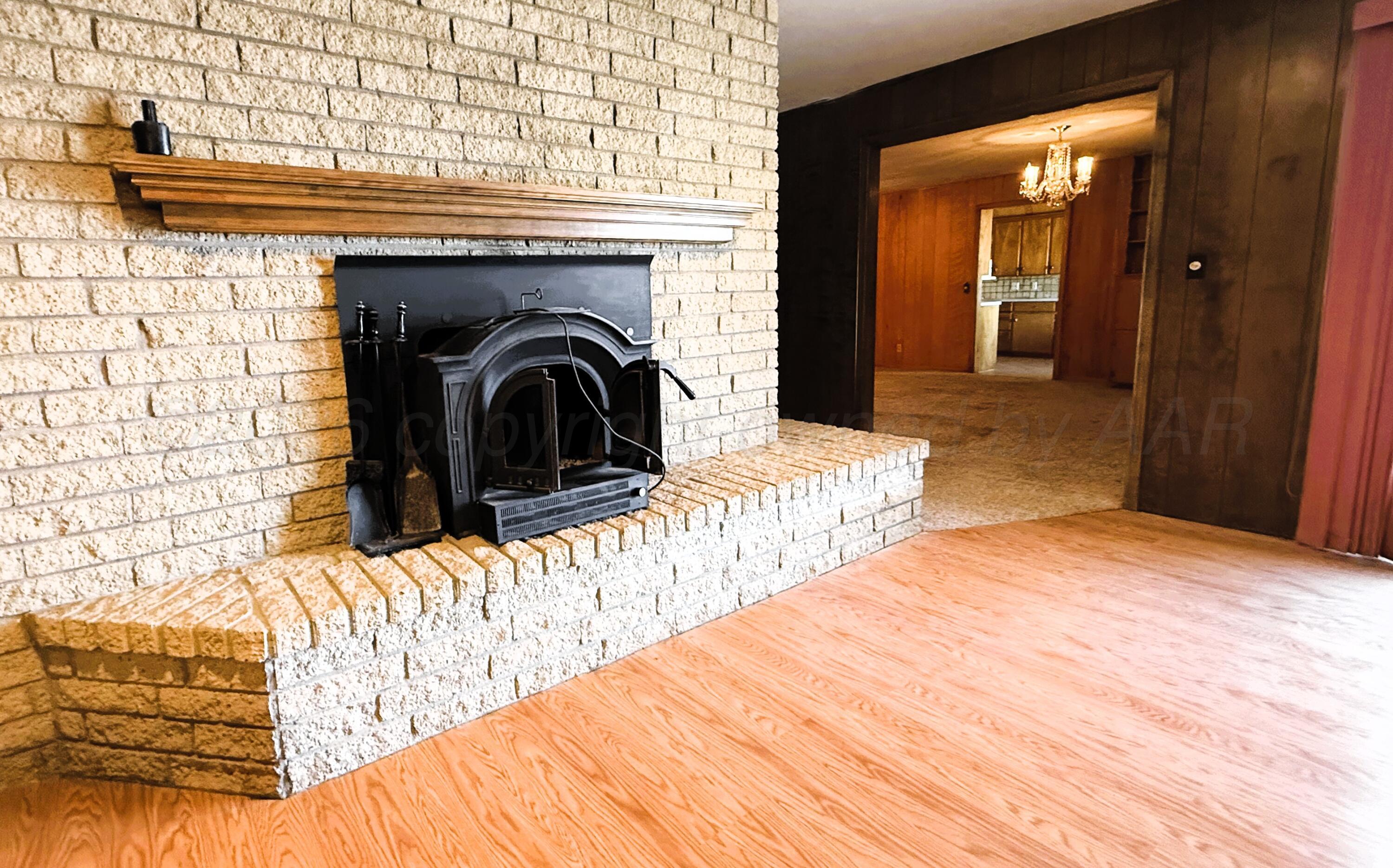 613 South Pearl Street Stratford, TX 79084 - Photo 23 of 32 Den Fireplace