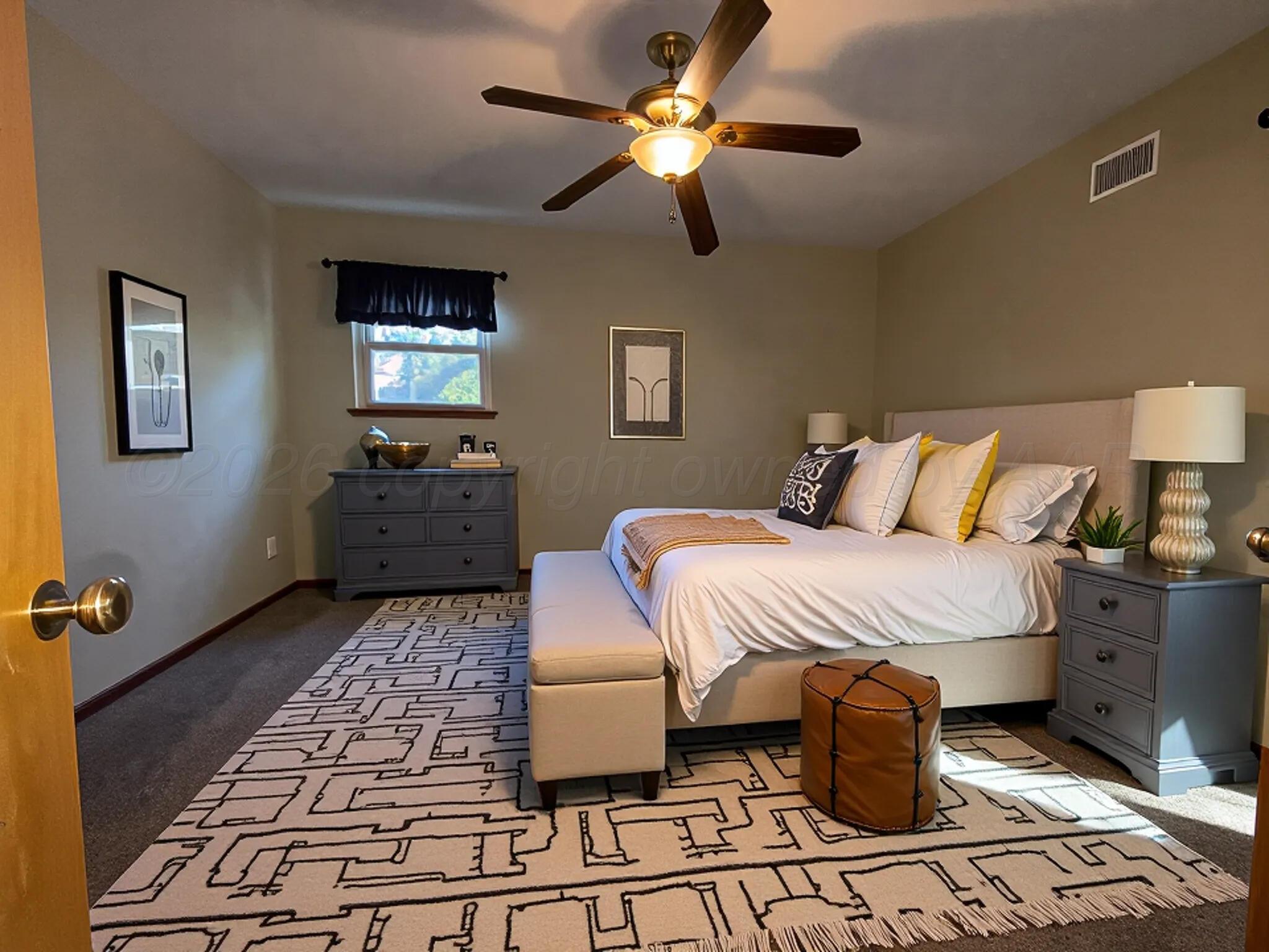 613 South Pearl Street Stratford, TX 79084 - Photo 26 of 32 a bedroom with a bed and a chandelier