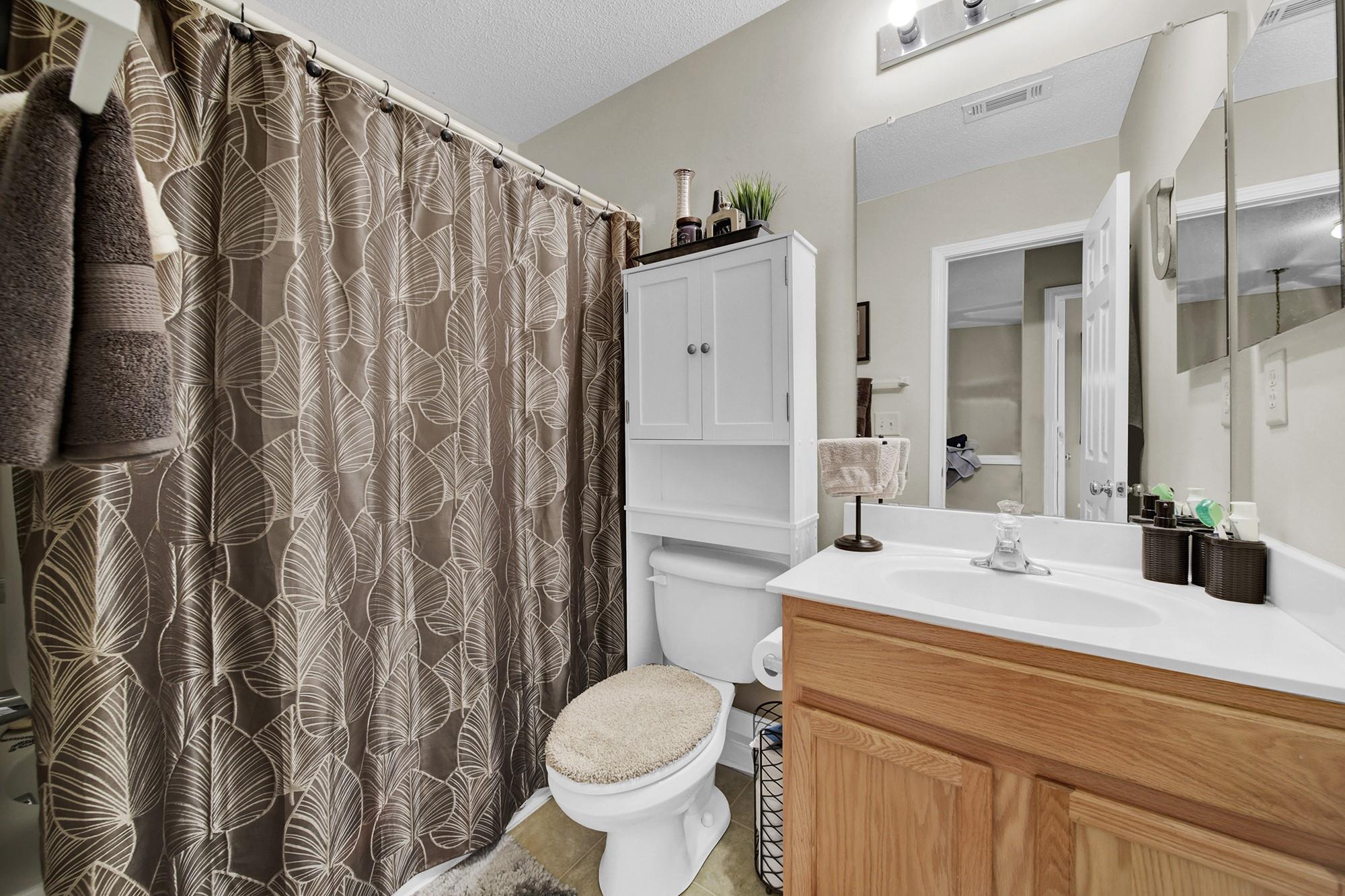 11223 Grass Field Road Charlotte, NC 28213 - Photo 14 of 25 a bathroom with a sink toilet and shower