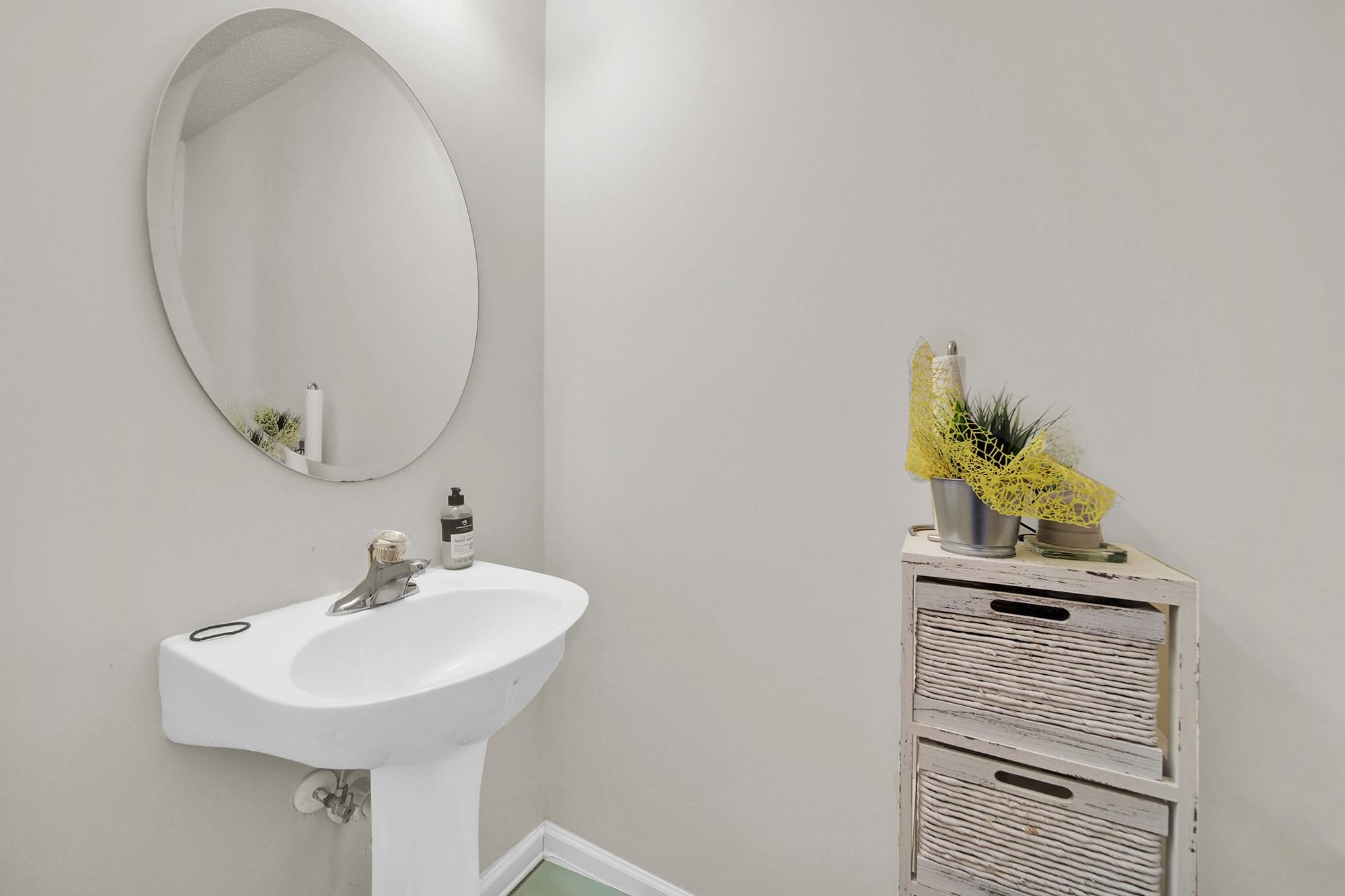 11223 Grass Field Road Charlotte, NC 28213 - Photo 16 of 25 a bathroom with a sink a mirror and a toilet