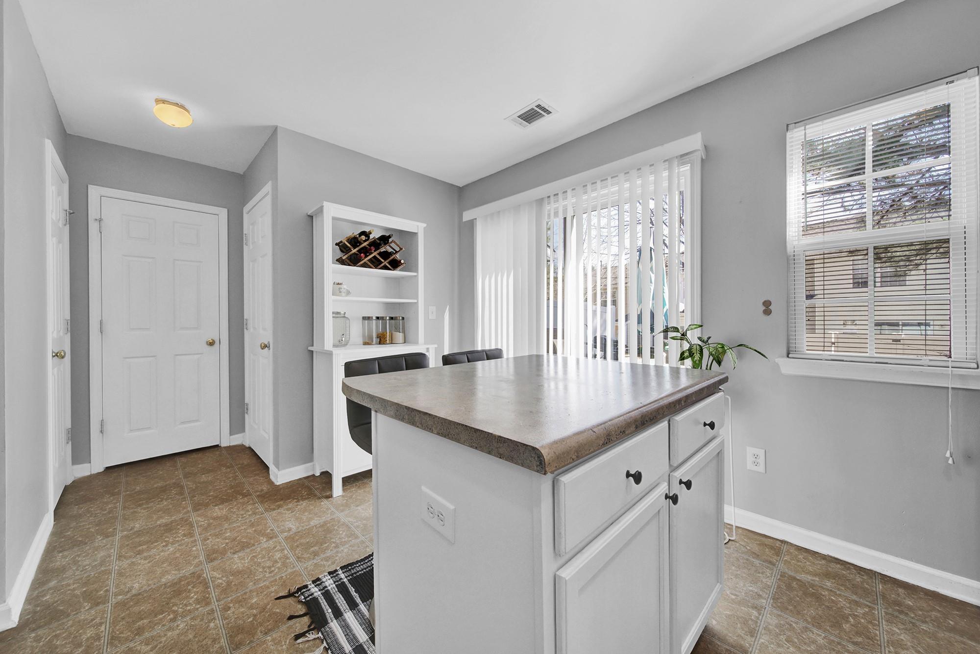 11223 Grass Field Road Charlotte, NC 28213 - Photo 18 of 25 a kitchen with a stove a sink and a refrigerator