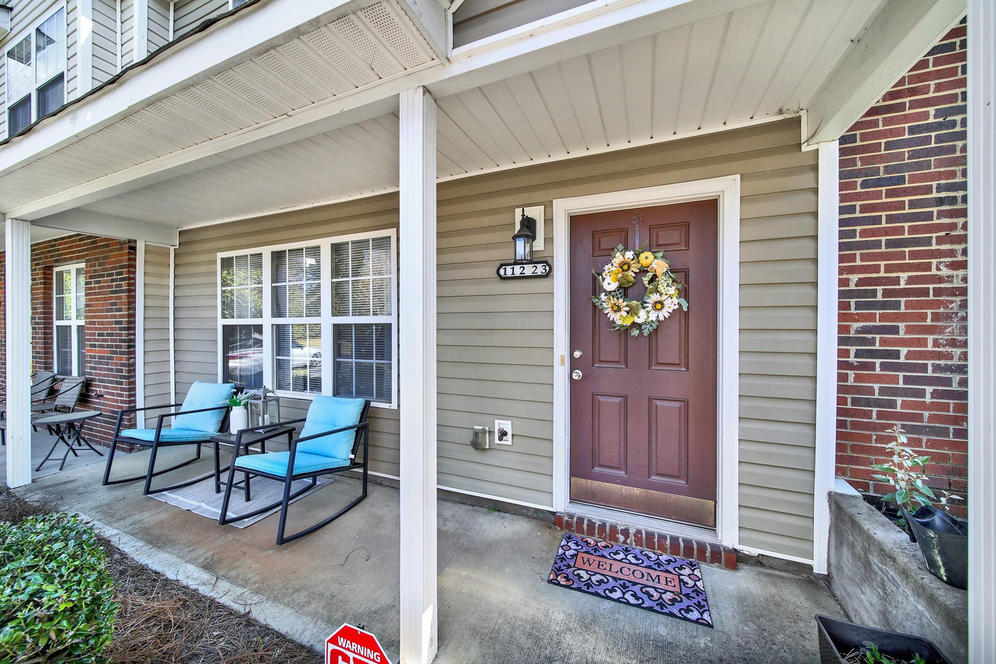 11223 Grass Field Road Charlotte, NC 28213 - Photo 3 of 25 a front view of a house with outdoor seating