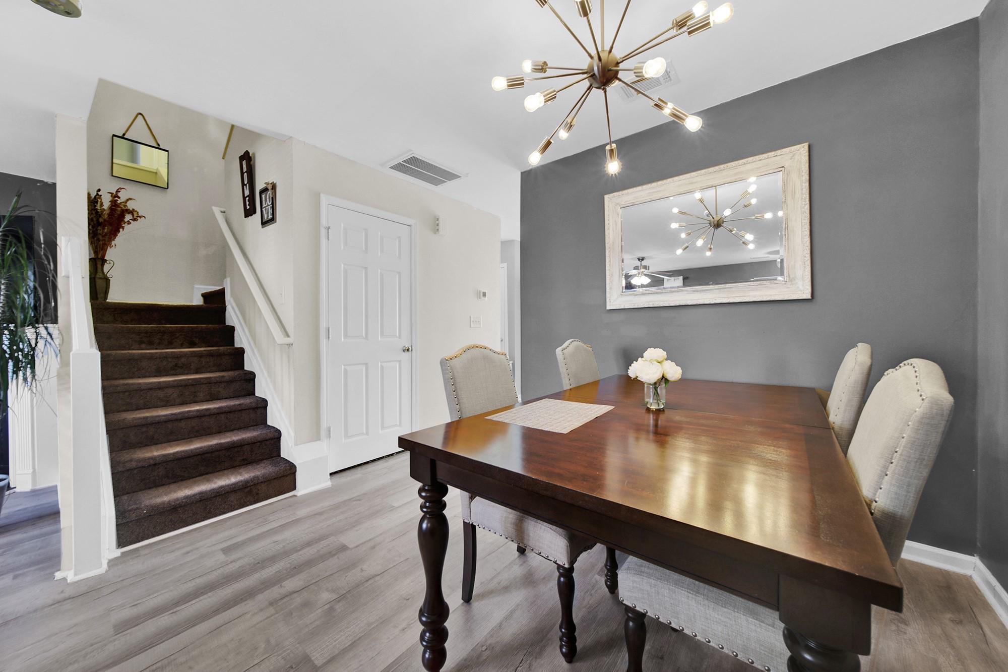 11223 Grass Field Road Charlotte, NC 28213 - Photo 7 of 25 a view of a dining room with furniture and wooden floor
