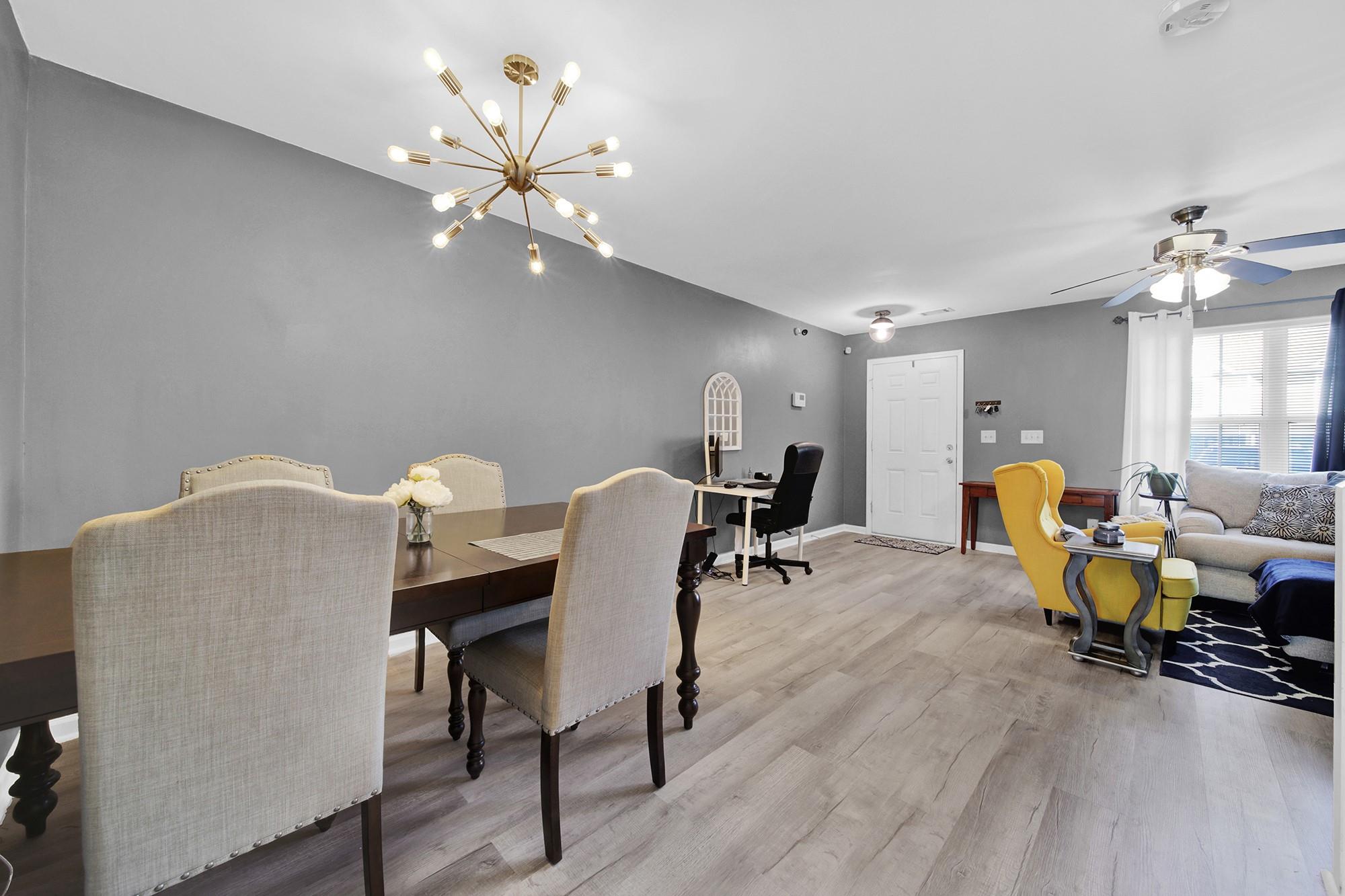 11223 Grass Field Road Charlotte, NC 28213 - Photo 8 of 25 a dining room with furniture and chandelier