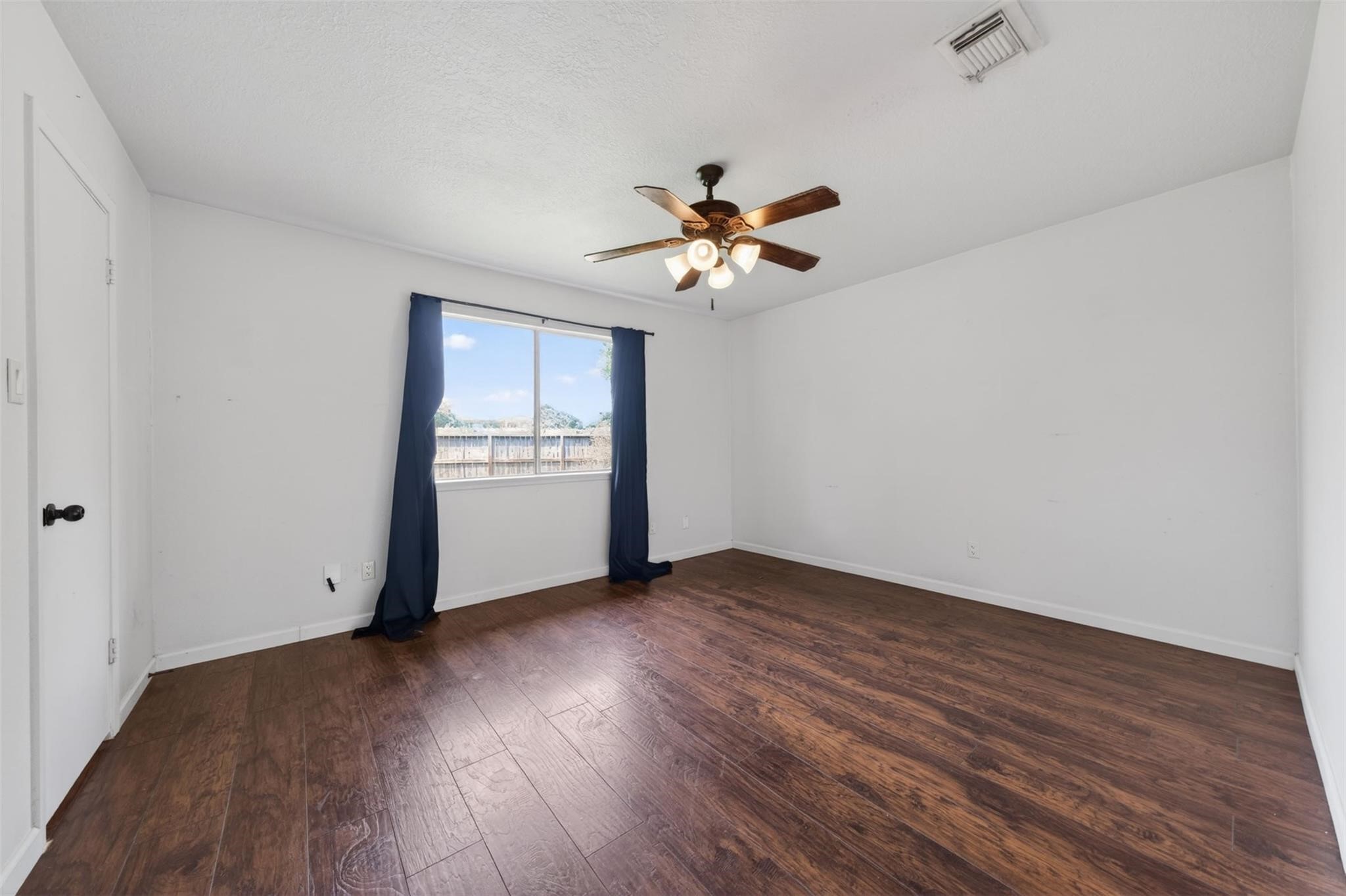 17002 Dew Drop Lane Houston, TX 77095 - Photo 22 of 24 a view of an empty room with window and wooden floor