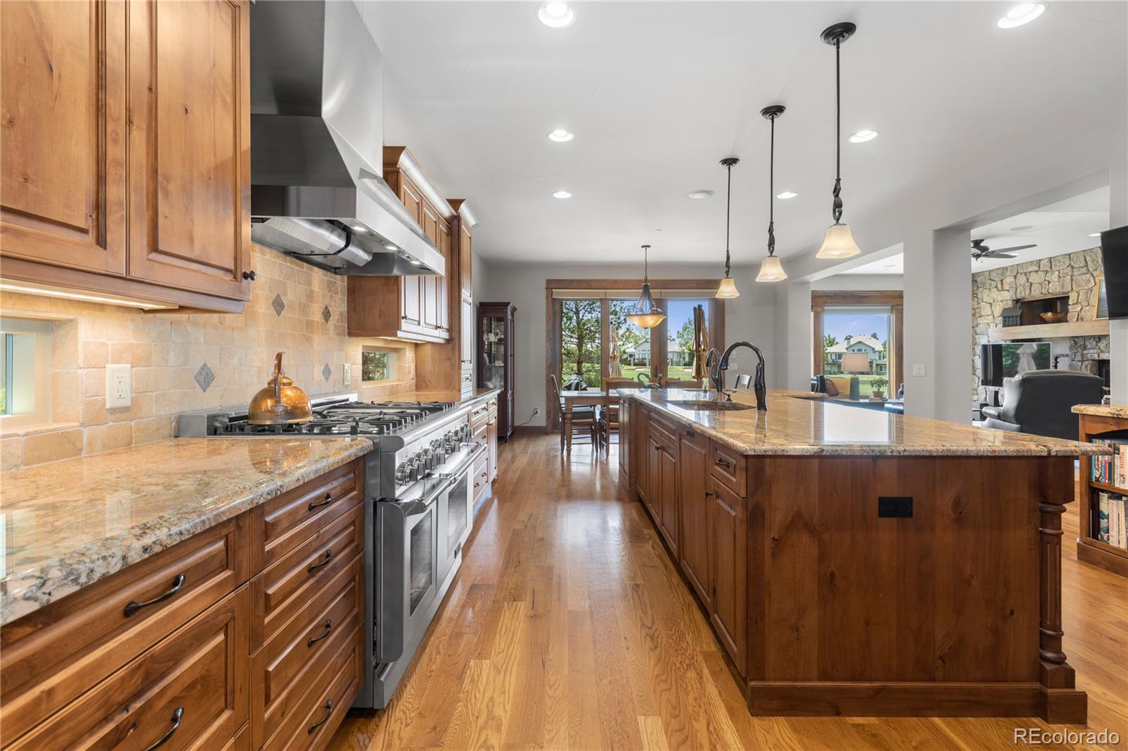 1291 Buffalo Ridge Road Castle Pines, CO 80108 - Photo 11 of 39 a large kitchen with stainless steel appliances granite countertop lots of counter top space