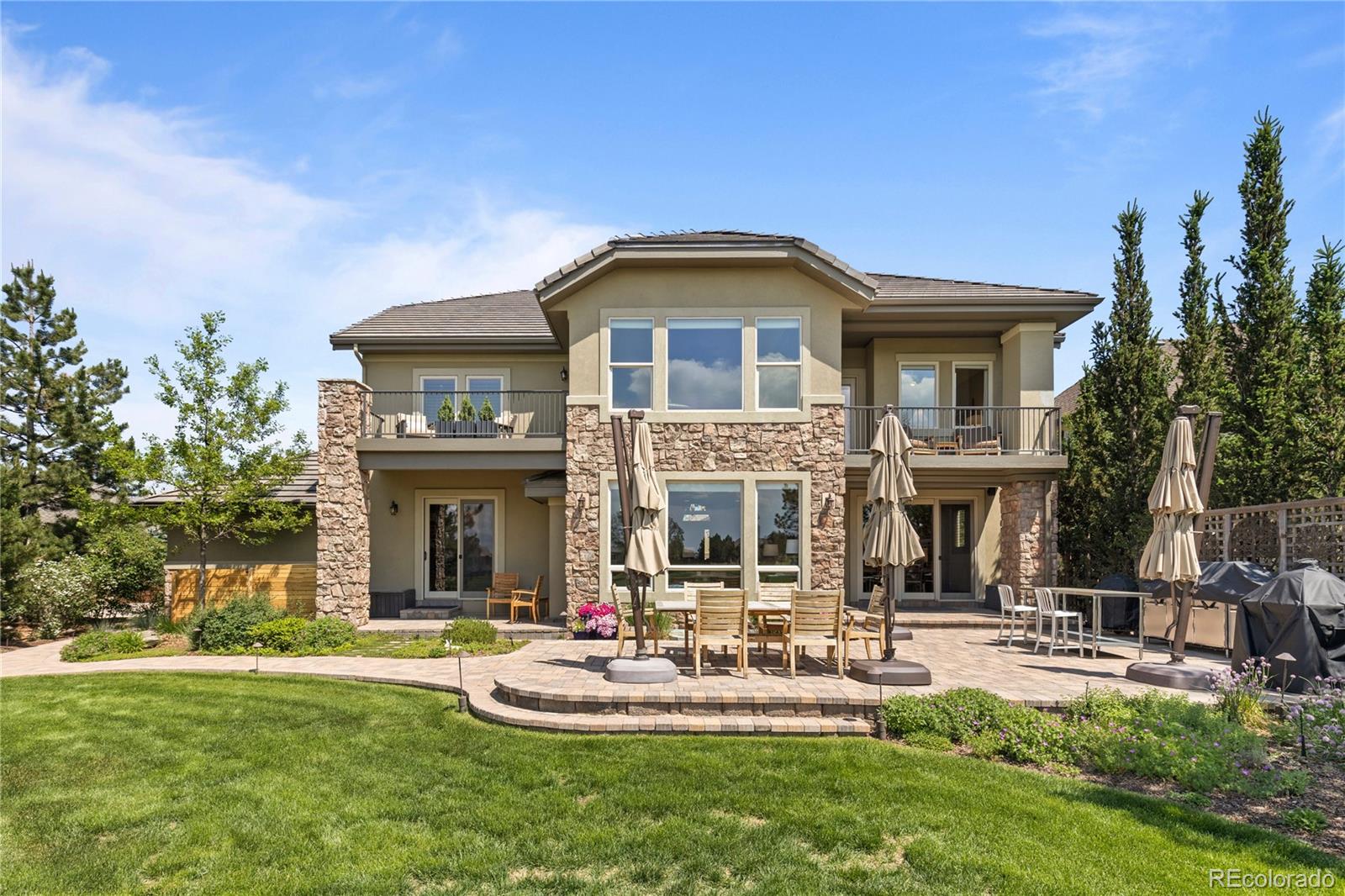 1291 Buffalo Ridge Road Castle Pines, CO 80108 - Photo 32 of 39 a front view of house with yard and outdoor seating