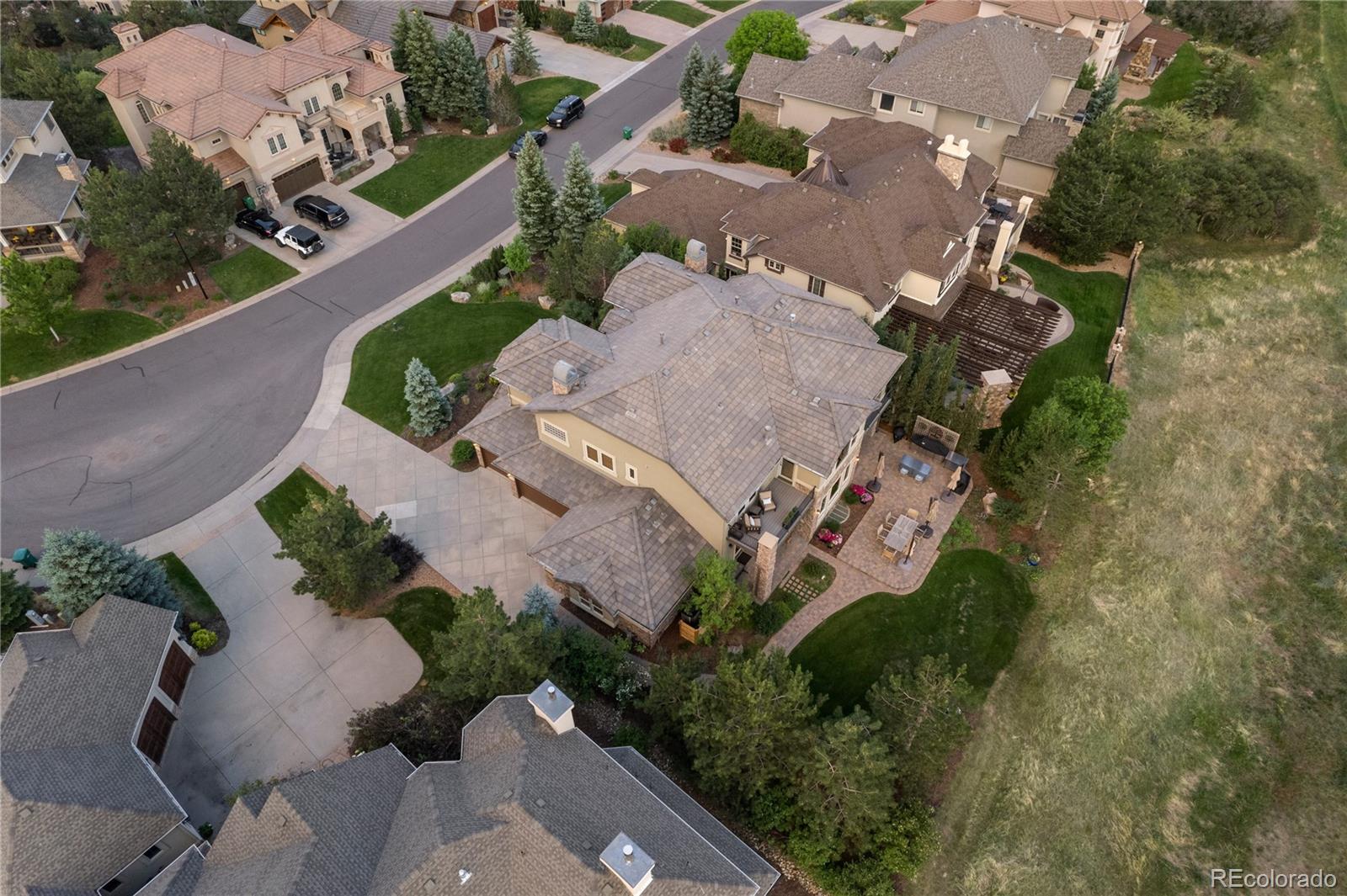 1291 Buffalo Ridge Road Castle Pines, CO 80108 - Photo 36 of 39 an aerial view of a house with a yard