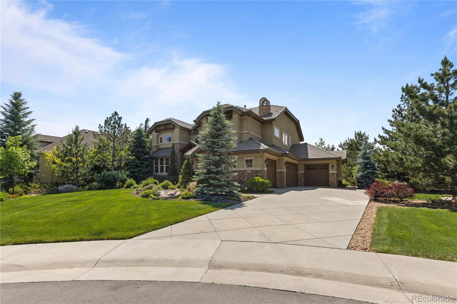 1291 Buffalo Ridge Road Castle Pines, CO 80108 - Photo 38 of 39 a front view of a house with a yard and garage