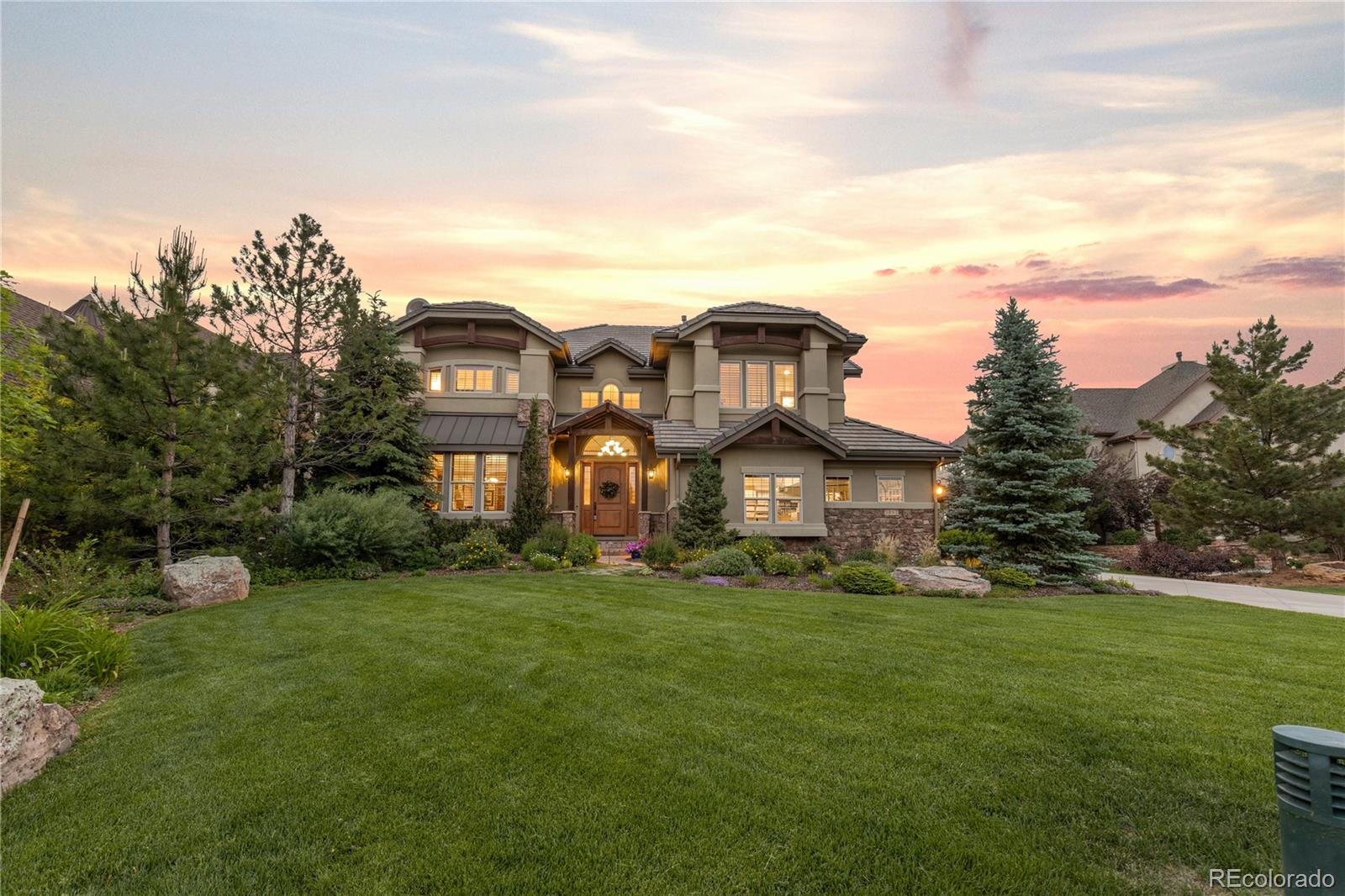 1291 Buffalo Ridge Road Castle Pines, CO 80108 - Photo 39 of 39 a view of a big house with a big yard and large trees