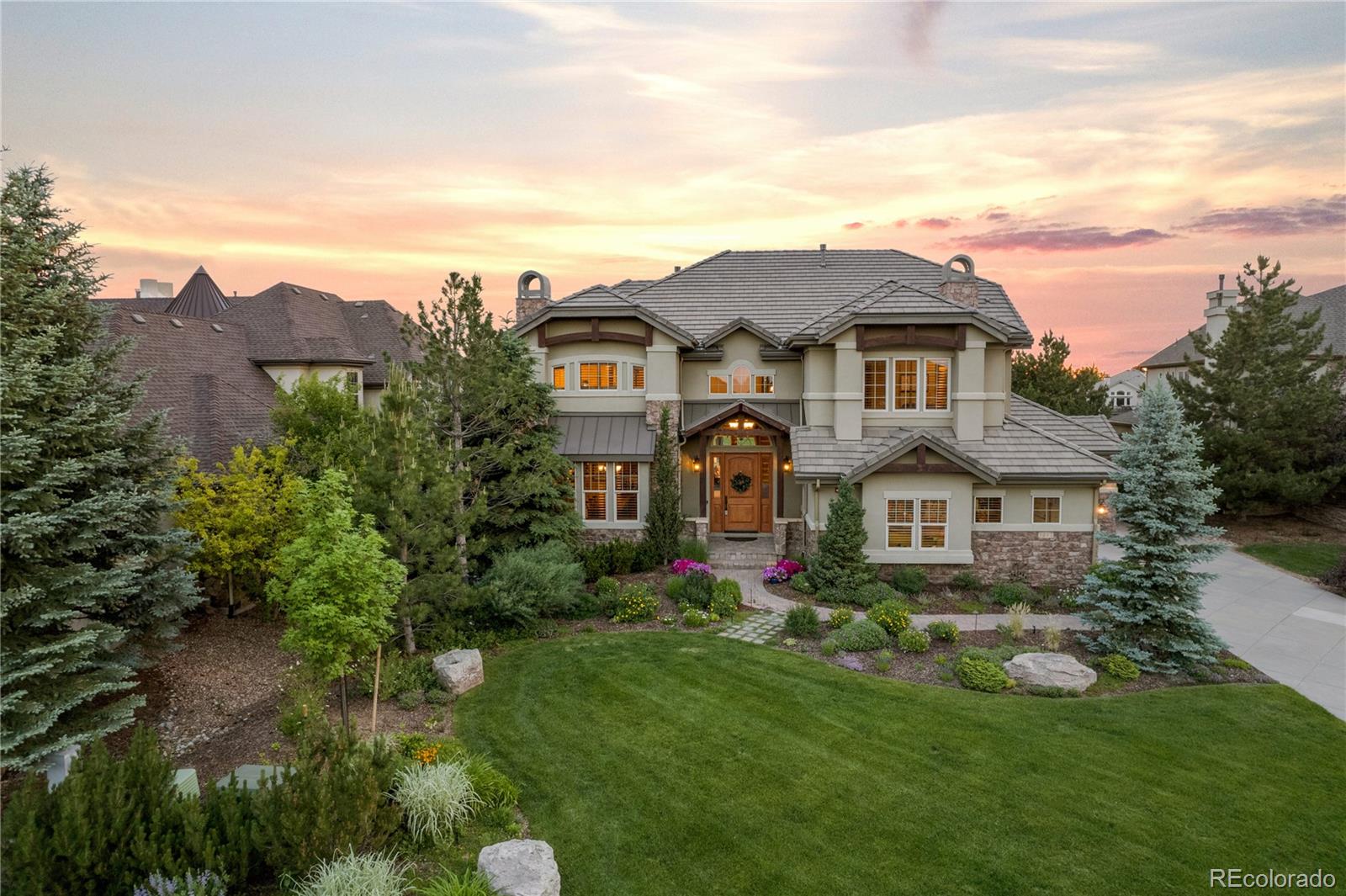 1291 Buffalo Ridge Road Castle Pines, CO 80108 - Photo 4 of 39 a front view of house with yard and green space