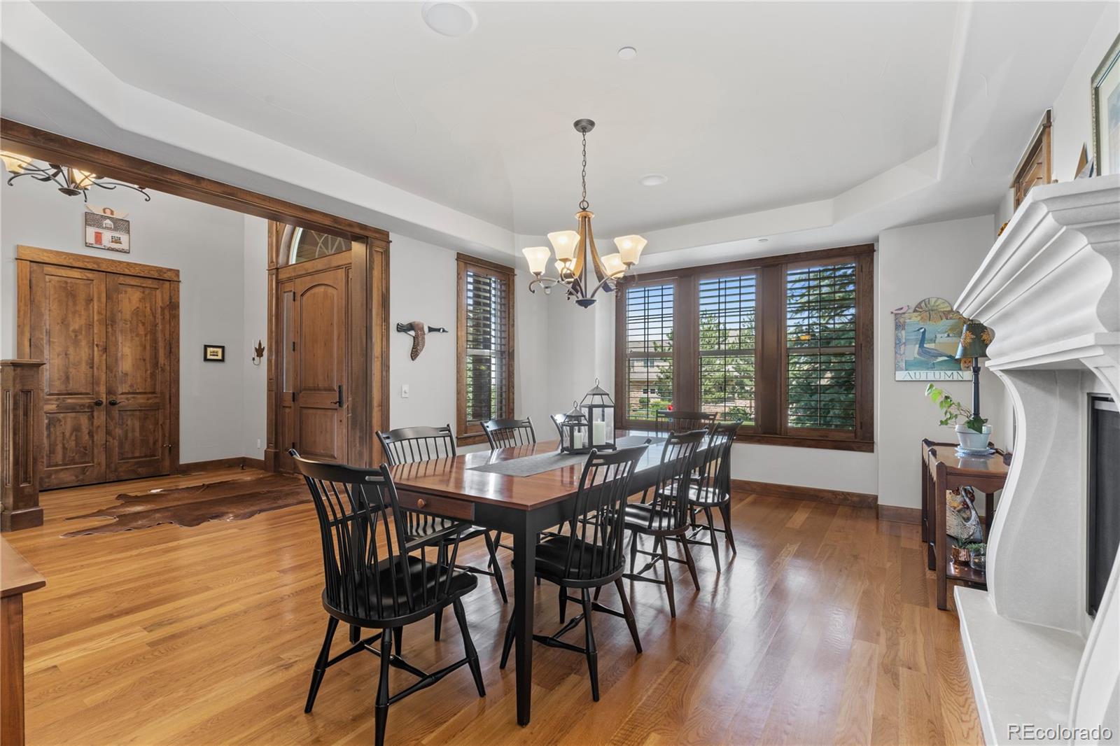 1291 Buffalo Ridge Road Castle Pines, CO 80108 - Photo 7 of 39 a view of a a dining room with furniture window and wooden floor