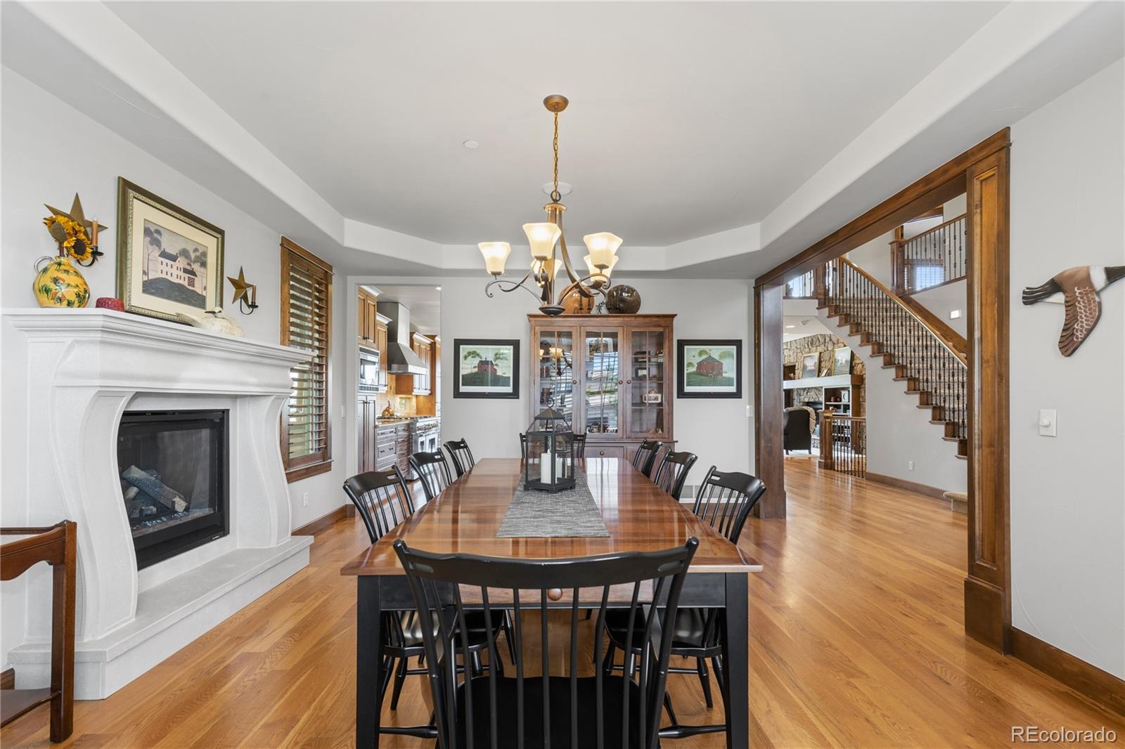 1291 Buffalo Ridge Road Castle Pines, CO 80108 - Photo 8 of 39 a dining room with furniture a chandelier and wooden floor