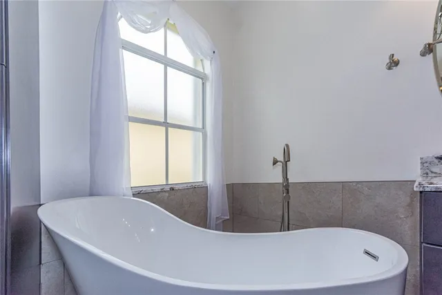 a white bath tub sitting in a bathroom
