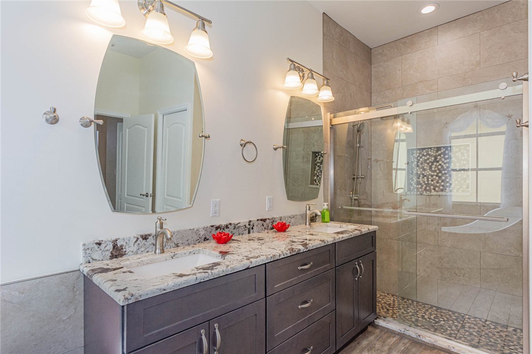 5952 Spanish River Road Fort Pierce, FL 34951 - Photo 15 of 35 a bathroom with a granite countertop sink mirror and double