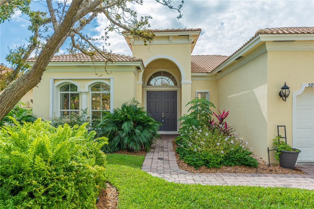 5952 Spanish River Road Fort Pierce, FL 34951 - Photo 2 of 35 a front view of a house with a garden