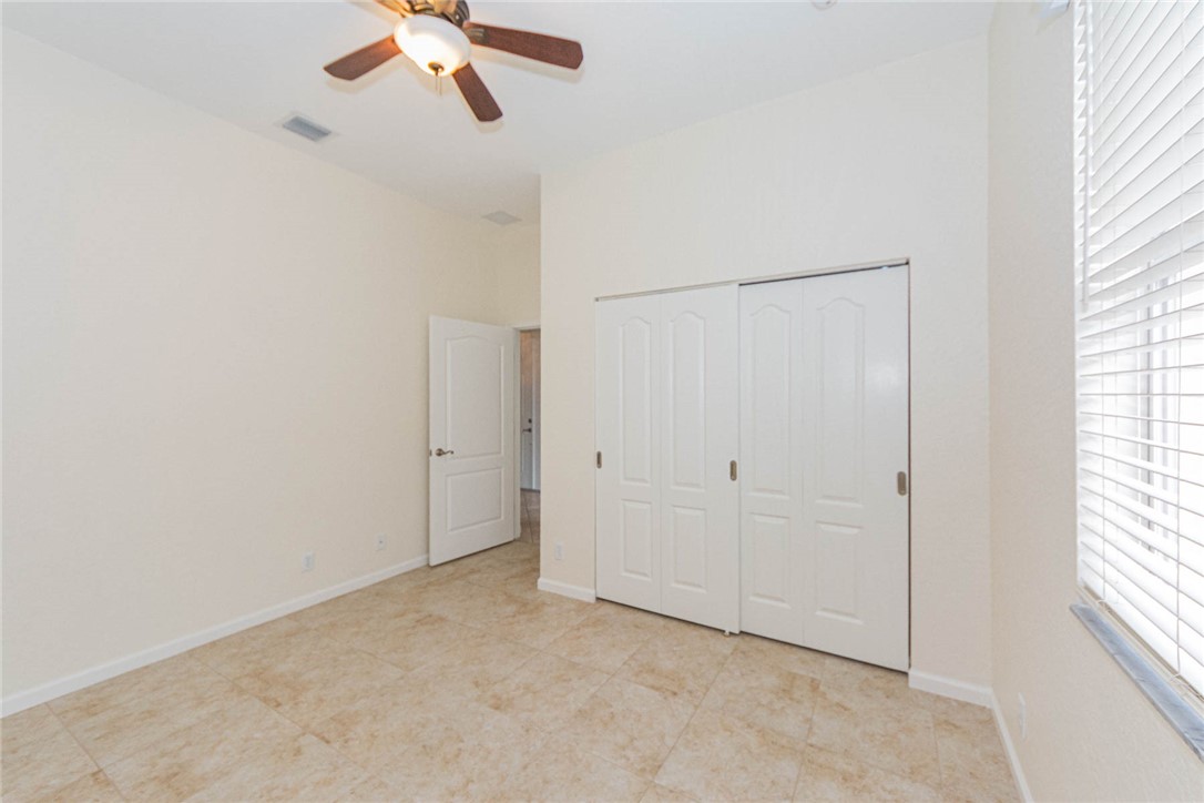 5952 Spanish River Road Fort Pierce, FL 34951 - Photo 22 of 35 an empty room with windows and fan