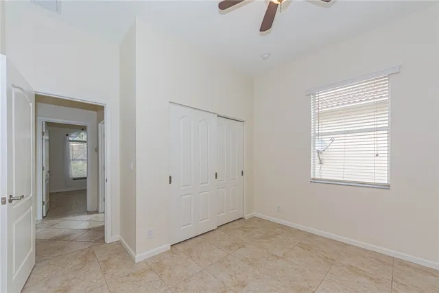 an empty room with windows and closet