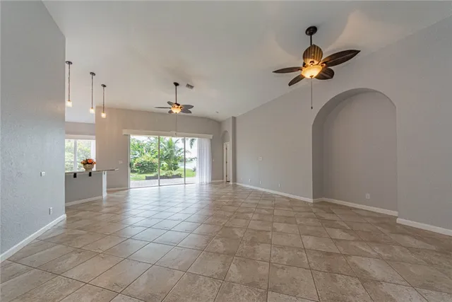 a view of hallway with a chandelier fan and wooden floor