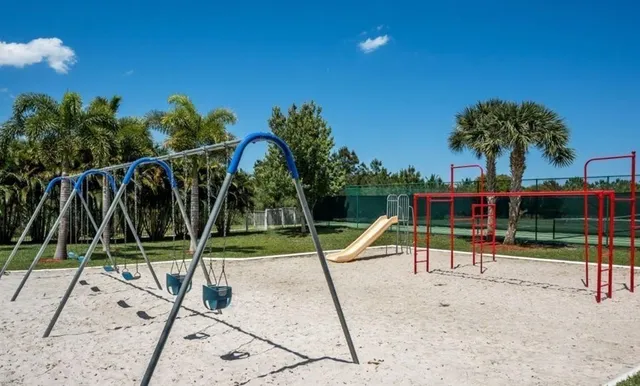 a view of a park with swings and slide