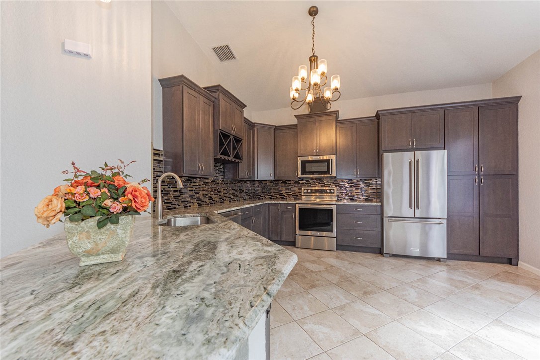 5952 Spanish River Road Fort Pierce, FL 34951 - Photo 6 of 35 a view of a kitchen with a sink and a stove top oven