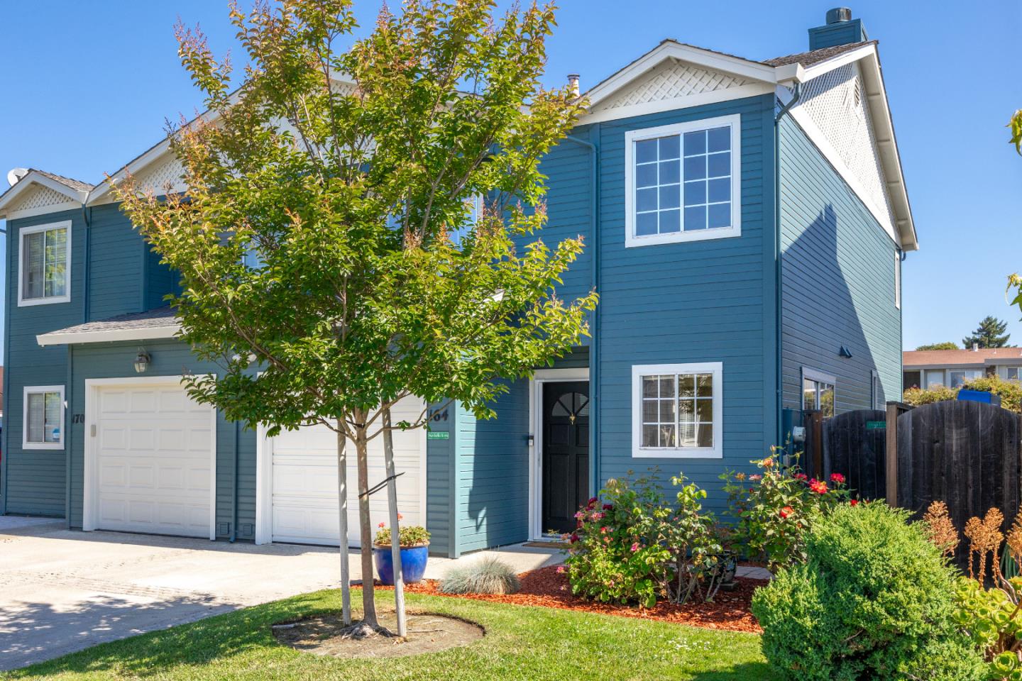 a front view of a house with garden