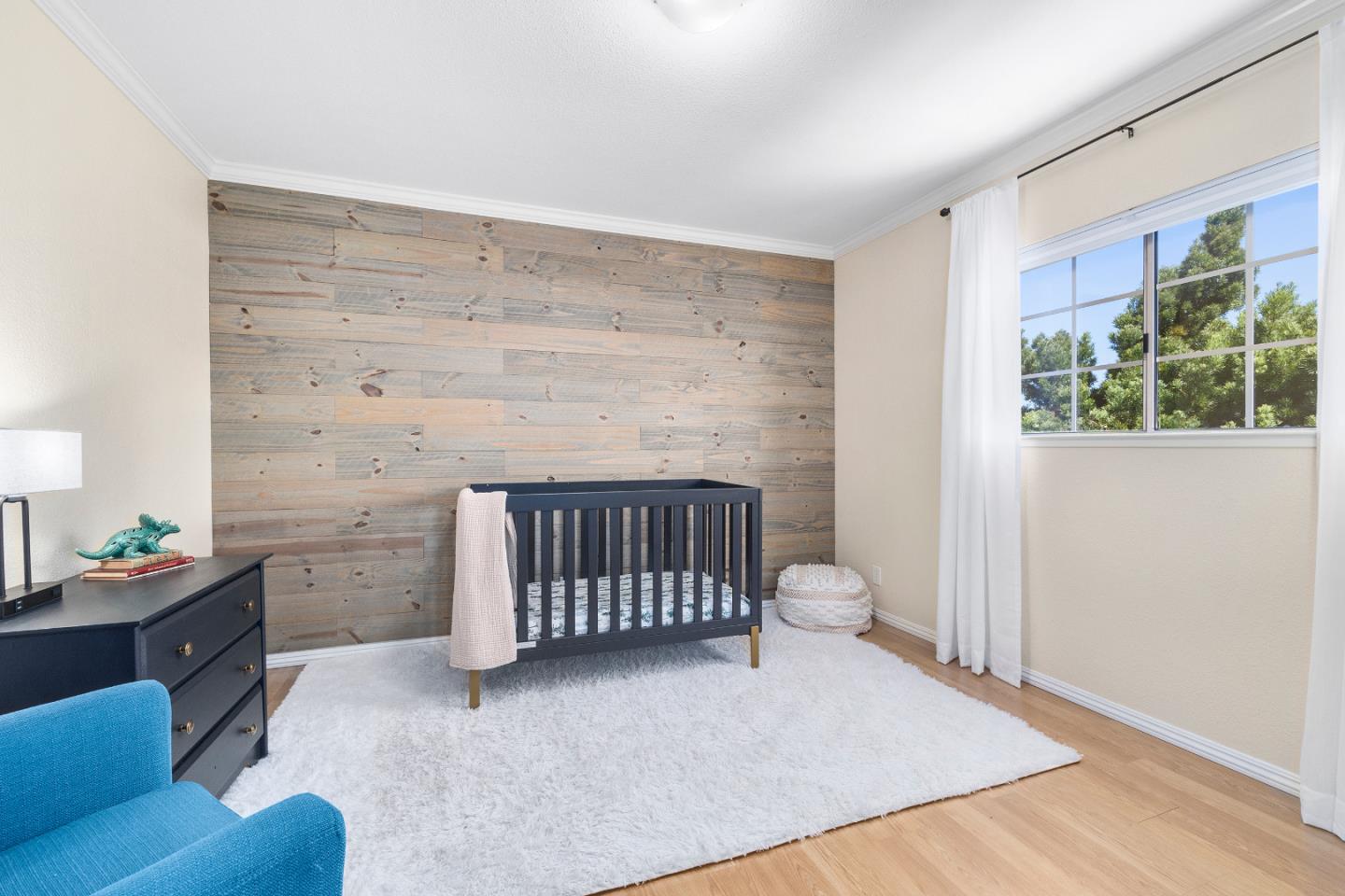 164 Weeks Drive Watsonville, CA 95076 - Photo 22 of 37 a bedroom with a baby bed a couch and a window