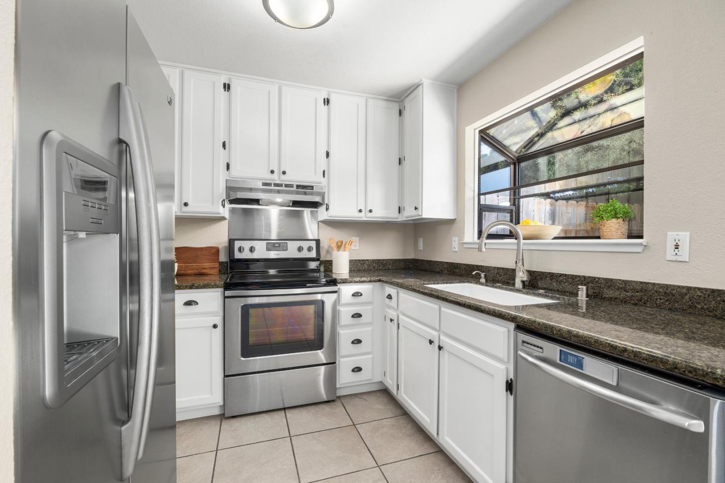 164 Weeks Drive Watsonville, CA 95076 - Photo 8 of 37 a kitchen with stainless steel appliances granite countertop a sink stove and refrigerator