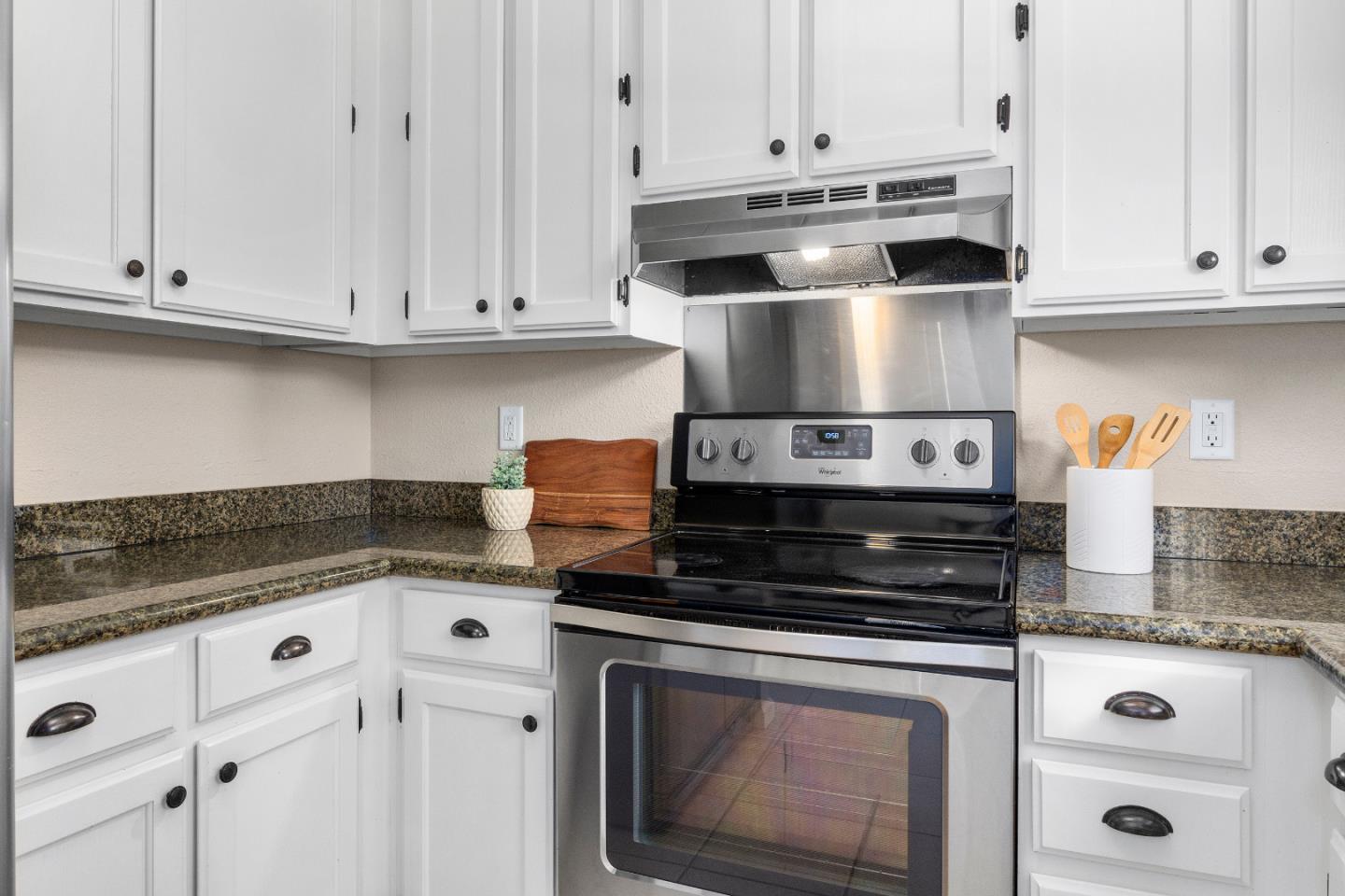 164 Weeks Drive Watsonville, CA 95076 - Photo 10 of 37 a kitchen with granite countertop white cabinets and appliances