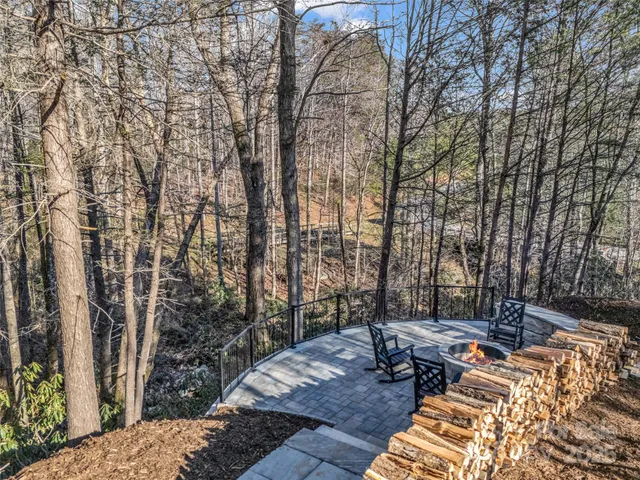 a view of backyard with table and chairs and wooden fence